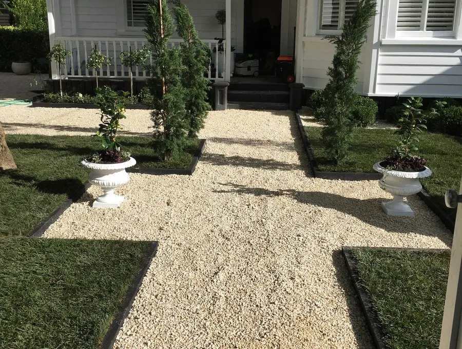 Gravel courtyard with topiary and urns